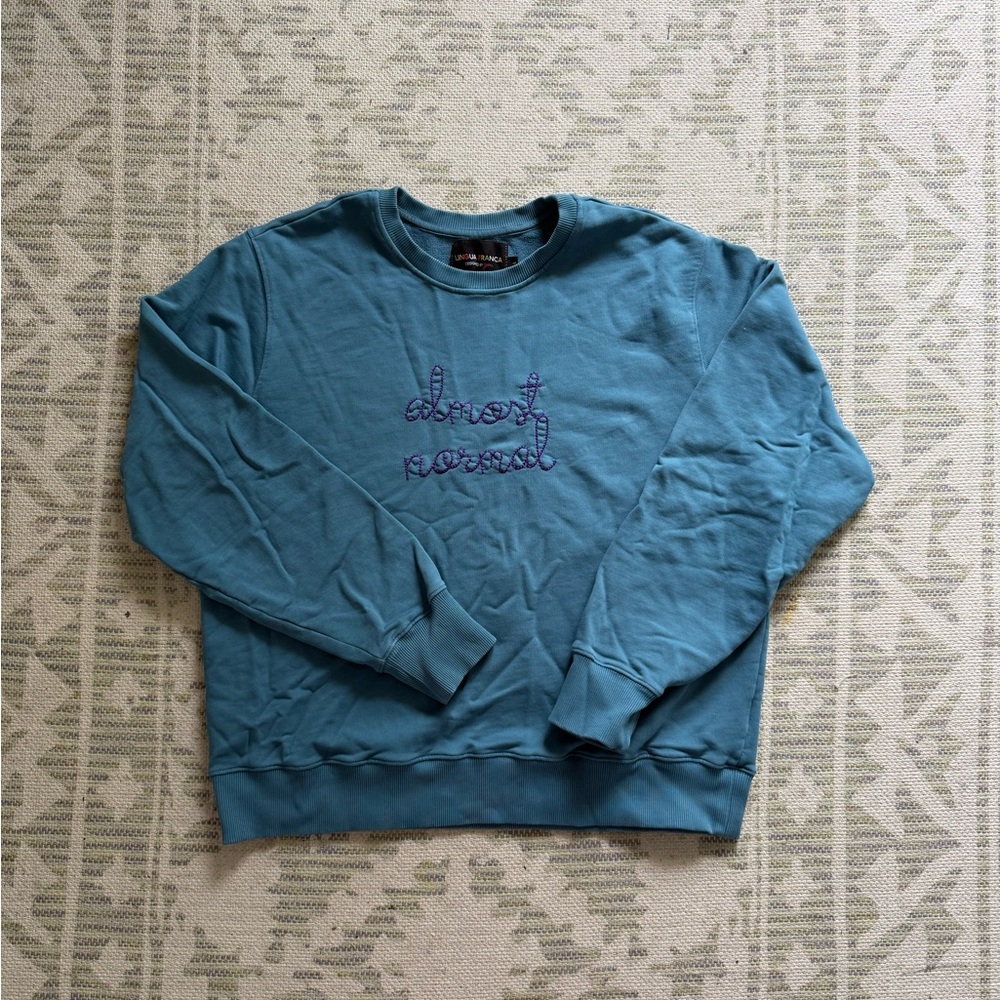 Lingua Franca sweatshirt. Blue with purple embroidery. Almost Normal.